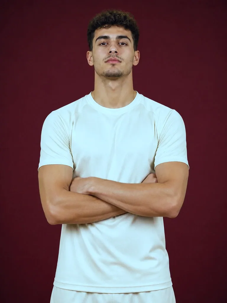 Nil in a plain cream training top against a garnet backdrop